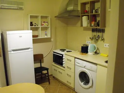a kitchen with a white refrigerator and a washing machine at Julia Garden in Burgas City