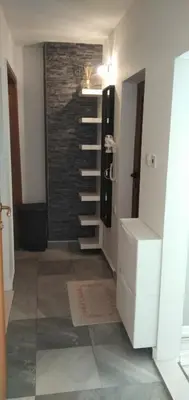 a bathroom with a sink and a brick wall at Draga Apartment in Nesebar