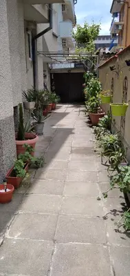 a walkway with potted plants on the side of a building at Draga Apartment in Nesebar