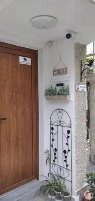 a front door of a house with a sign on the wall at Draga Apartment in Nesebar