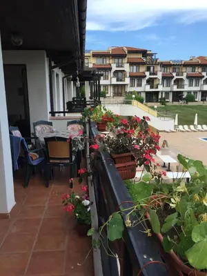 a balcony with potted plants and a view of buildings at Apartment on the sea at St Nikolas Complex-Veronika in Chernomorets