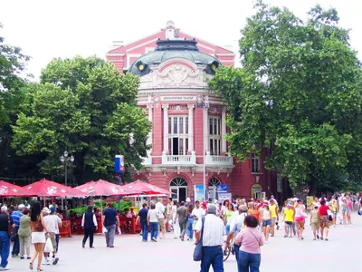 a crowd of people walking in front of a building at Apartment Kafedral in Varna City