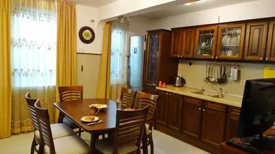 a kitchen with a table and a dining room at Apartment Kafedral in Varna City