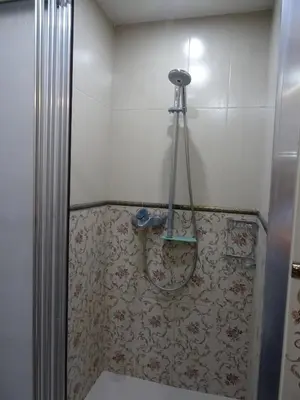 a shower in a bathroom with a shower curtain at Apartment Kafedral in Varna City