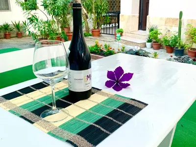 a bottle of wine and a glass on a table at Guest House Briz in Nesebar