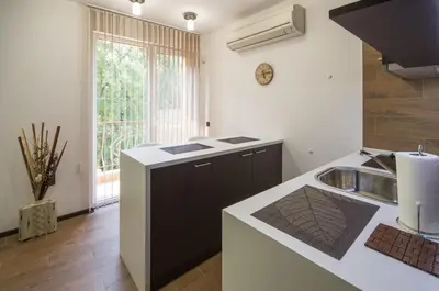 a kitchen with a sink and a counter top at City Apartments La Casa in Varna City