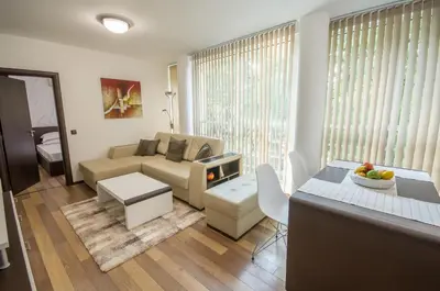 a living room with a couch and a table at City Apartments La Casa in Varna City
