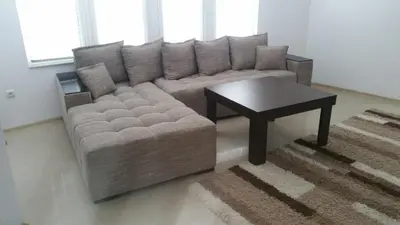 a living room with a couch and a table at 4U Apartment in Burgas City
