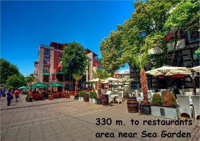 a city street with tables and chairs and buildings at 4U Apartment in Burgas City