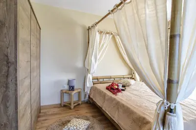 a bedroom with a bed with a canopy at Galata Residence in Varna City