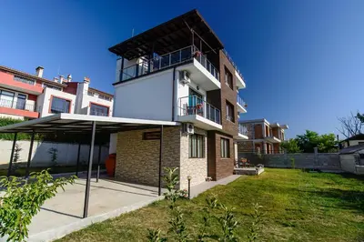 a building with an umbrella in front of it at Galata Residence in Varna City
