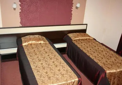 a room with two beds in a room at Hotel Elegant in Karnobat