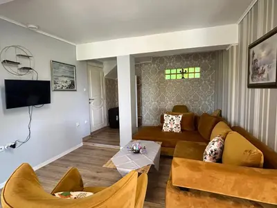 a living room with a couch and a table at Vila Sofia - Pool, Sauna & Nature Escape in Varna City
