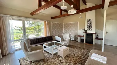 a living room with a couch and a table at Vila Sofia - Pool, Sauna & Nature Escape in Varna City