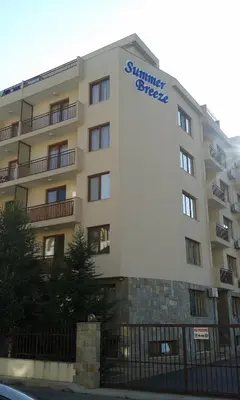 a building with a sign on the side of it at Summer Breeze Apartments in Sunny Beach