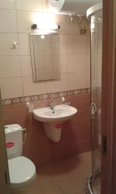 a bathroom with a sink and a toilet and a mirror at Summer Breeze Apartments in Sunny Beach