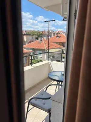 a view of a balcony with a table and chairs at Milchevi Guesthouse in Sozopol