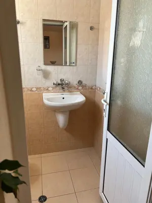 a bathroom with a sink and a mirror at Milchevi Guesthouse in Sozopol