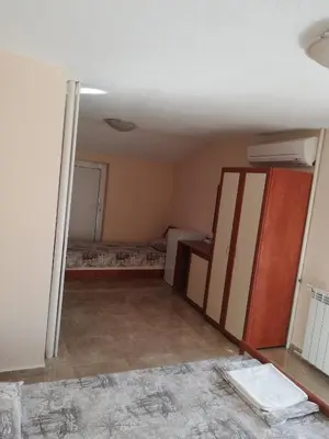 a room with a bed and a cabinet in it at Milchevi Guesthouse in Sozopol