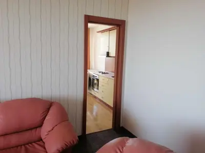 a room with a mirror and a couch and a kitchen at St. George Guest House in Sveti Vlas