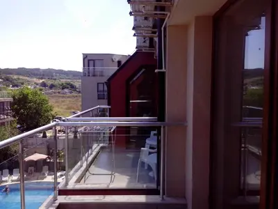 a balcony with a view of a swimming pool at Sea'n'Pool Apartments in Hotel in Sozopol