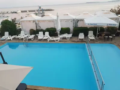 a view of a swimming pool with chairs and umbrellas at Complex Top Apartment in Sveti Vlas