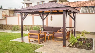 a gazebo with two chairs and a table at Guest House Meridi in Priseltsi