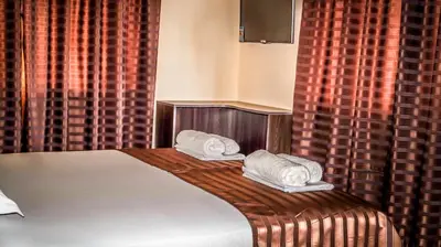 a bedroom with a bed with two towels on it at Guest House Meridi in Priseltsi