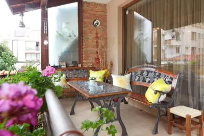 a patio with a table and chairs on a balcony at Nirvana Guest House in Nesebar