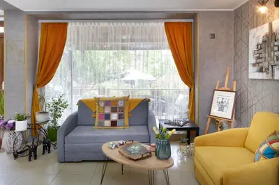 a living room with a couch and a table at Nirvana Guest House in Nesebar
