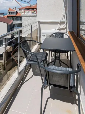 a balcony with two chairs and a table at Home Gramatikovi in Pomorie