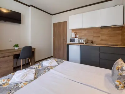 a hotel room with a bed and a kitchen at Home Gramatikovi in Pomorie