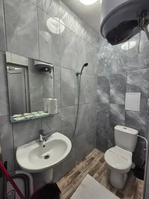 a bathroom with a toilet and a sink at Студио Лазур Поморие in Pomorie