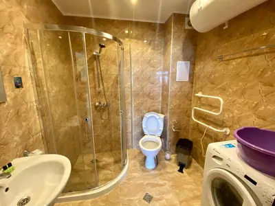 a bathroom with a shower and a toilet and a sink at Green Paradise Deluxe Apartments in Primorsko