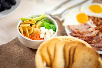 a bowl of food with an egg and a sandwich at Rome Palace Deluxe - All Inclusive Premium in Sunny Beach