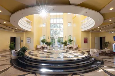 a lobby with a fountain in the middle of a building at Rome Palace Deluxe - All Inclusive Premium in Sunny Beach