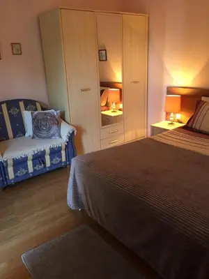 a bedroom with a bed and a dresser with a mirror at Siana 1 Apartment in Sveti Vlas