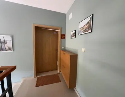 a hallway with a door and a wooden cabinet at Paradise Bay D8 Apartment in Sozopol