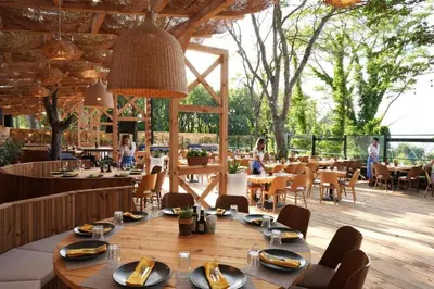 a restaurant with a large wooden table and chairs at Paradise Bay D8 Apartment in Sozopol