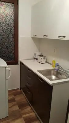 a kitchen with a sink and a counter top at Guest Rooms Old Captain in Burgas City