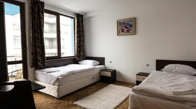 a bedroom with two beds and a window at Guest Rooms Old Captain in Burgas City