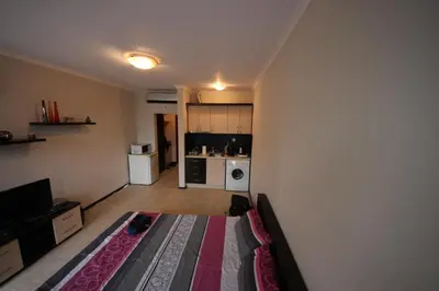 a living room with a bed and a kitchen at Menada Crystal Park Apartments in Sunny Beach
