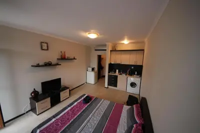 an empty living room with a kitchen and a living room at Menada Crystal Park Apartments in Sunny Beach