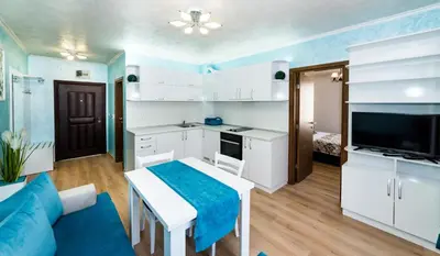 a kitchen and living room with a blue and white room at Stela Apartments in Obzor