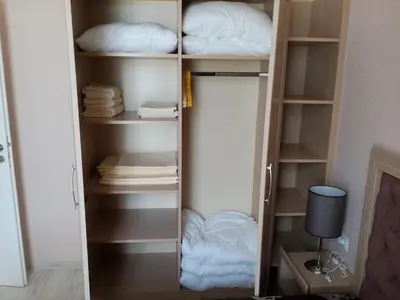 a book shelf with pillows and towels in a room at Private Apartments in Harmony Suites Dream Island in Sunny Beach