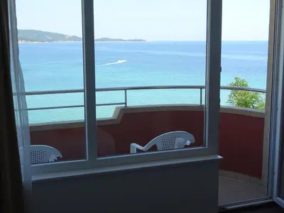 a view of the ocean from a room with a window at Dobrevi Guest House in Primorsko