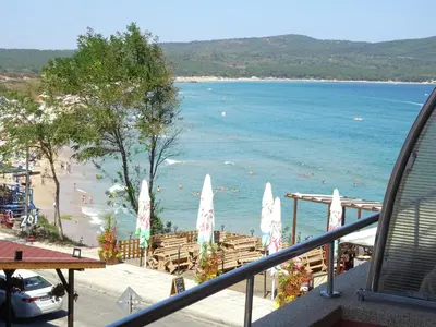 a view of a beach with people in the water at Dobrevi Guest House in Primorsko