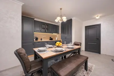 a dining room with a table and chairs at Prestige Central Apartments in Varna City