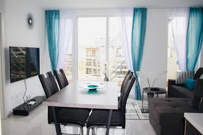 a living room with a table and chairs and a couch at Apartments in Sunny Island Complex in Chernomorets