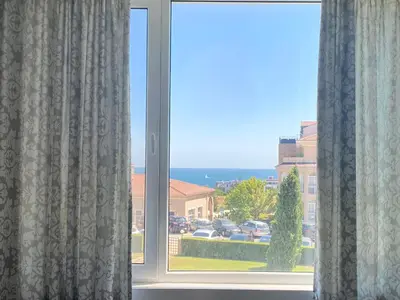 a window with a view of a parking lot at Apartments in Sunny Island Complex in Chernomorets